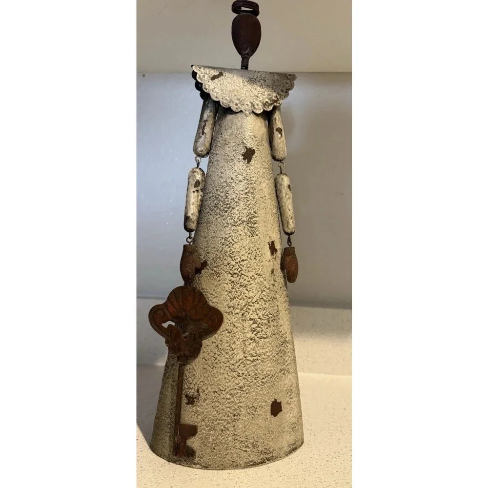 VTG decorative rustic metal sculpture of a stylized figure holding a large key.